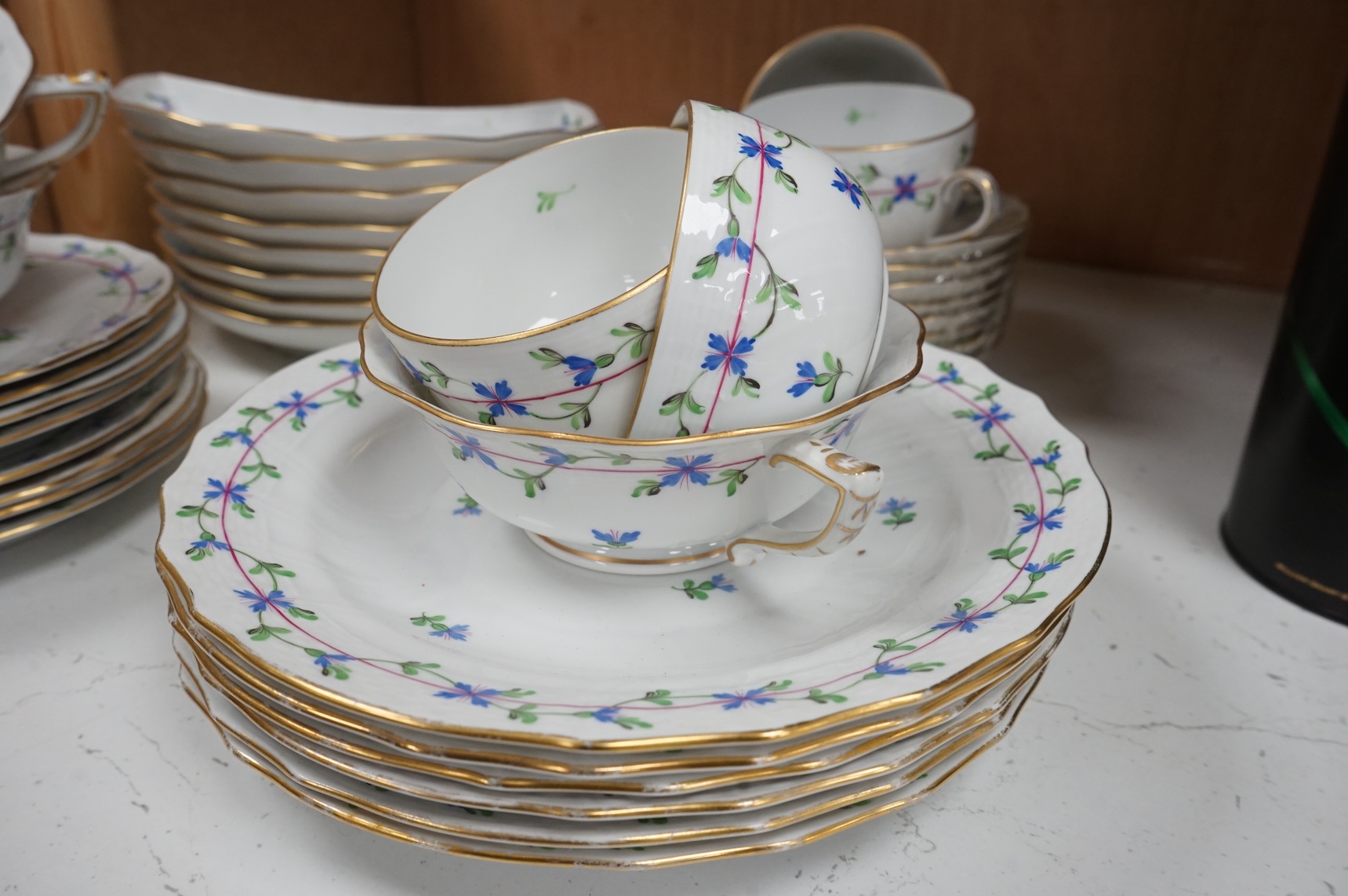 A Herend blue garland part tea set to include plates, twin handles cups and crescent dishes, largest 23cm in diameter